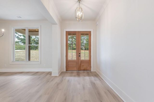 an empty room with windows and a fireplace