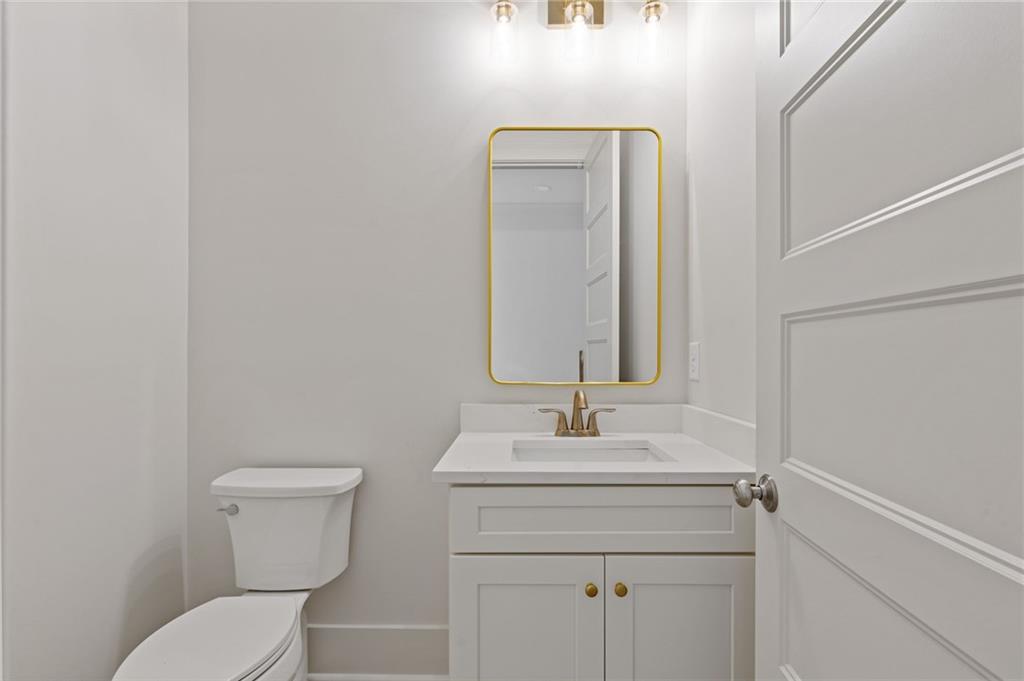 2001 Epperson Road Canton, GA 30115 - Photo 71 of 76 a bathroom with a toilet sink and mirror