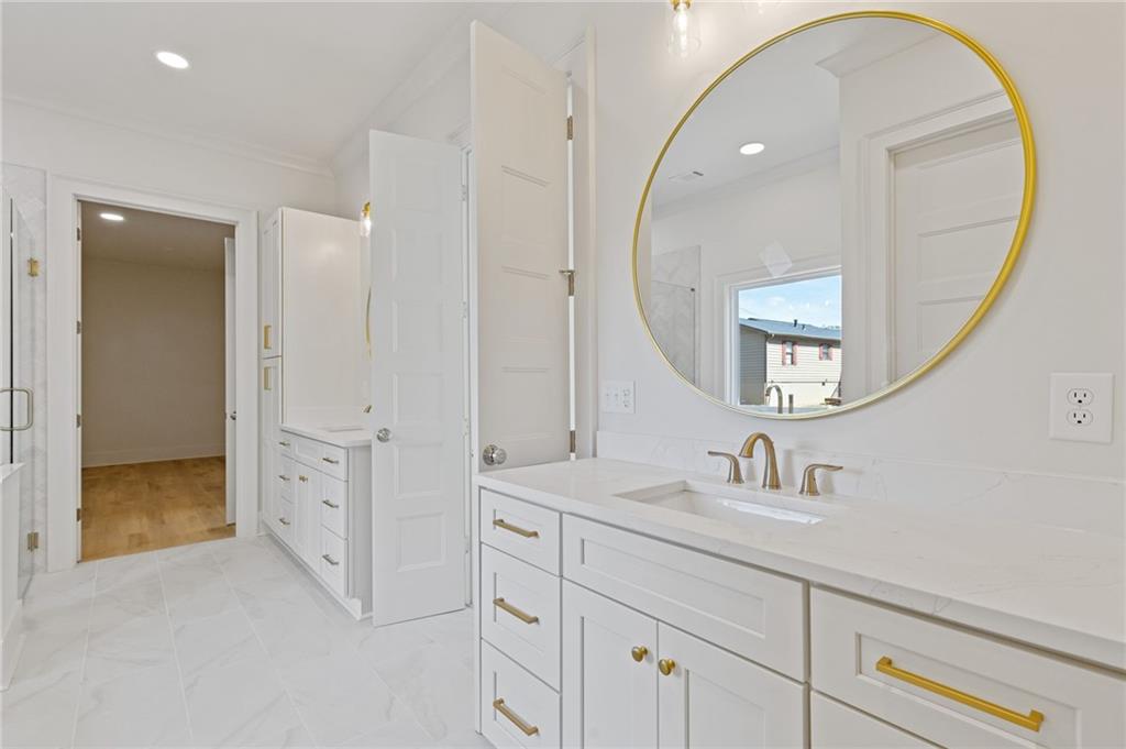 2001 Epperson Road Canton, GA 30115 - Photo 73 of 76 a en suite bathroom with a sink a mirror and a shower