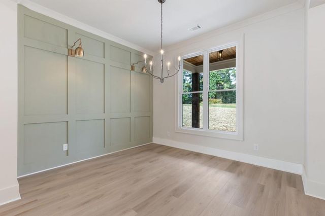 a view of an empty room with a fireplace and a window