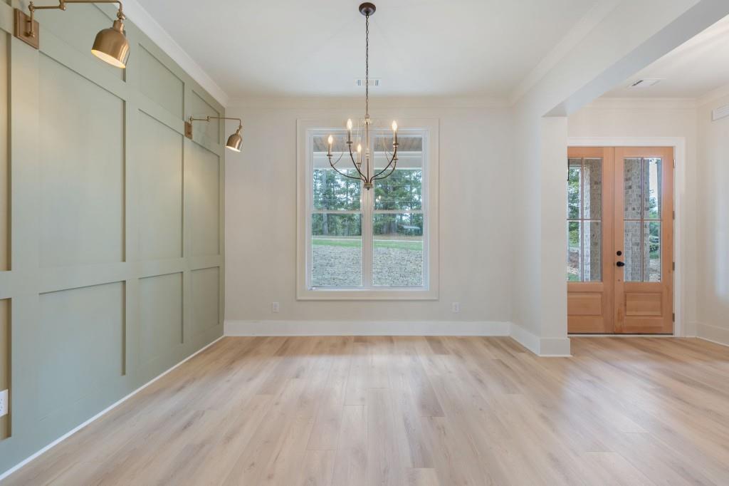 2001 Epperson Road Canton, GA 30115 - Photo 9 of 76 a view of an empty room with wooden floor and a window