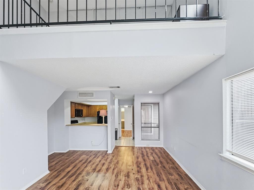 9835 Walnut Street, Unit 208 Dallas, TX 75243 - Photo 9 of 13 a view of a big room with wooden floor and windows