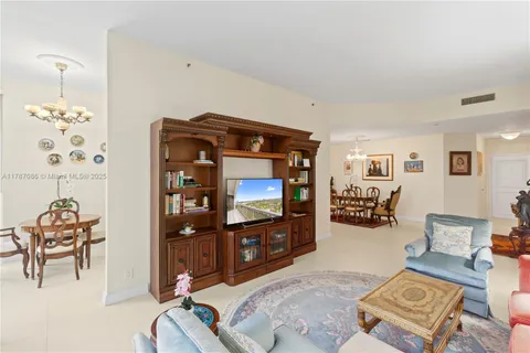 a living room with furniture a red couch and a bookshelf