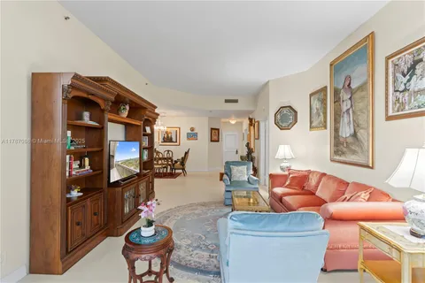 a large white kitchen with a sink stainless steel appliances and cabinets