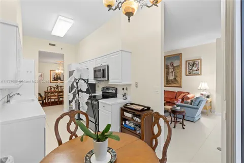 a kitchen with a refrigerator a stove and a dining table