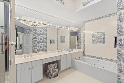 a bedroom with bed and a chandelier