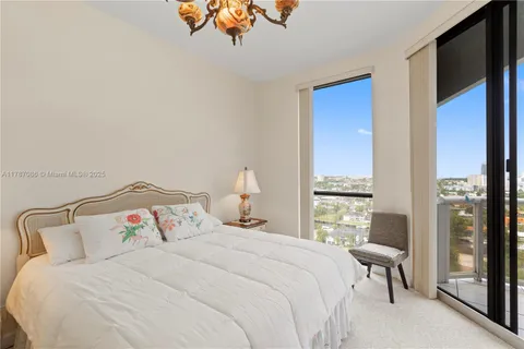a bedroom with two beds and a painting on the wall