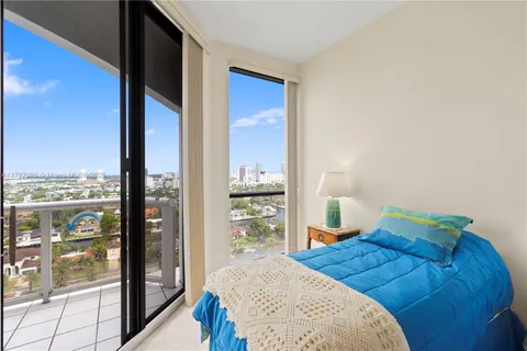 a bedroom with two beds and a painting on the wall