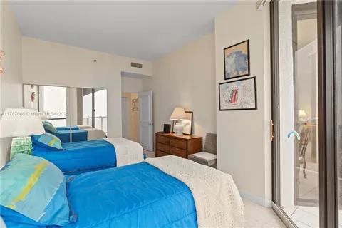 a view of a dining room with furniture water view and floor to ceiling window