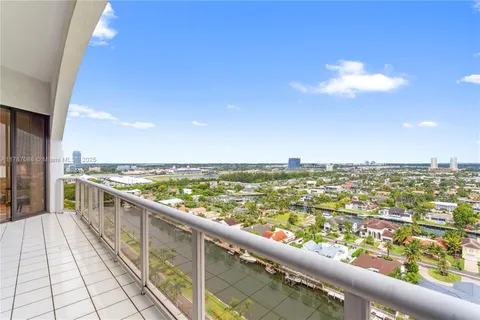 an aerial view of city lake and trees all around