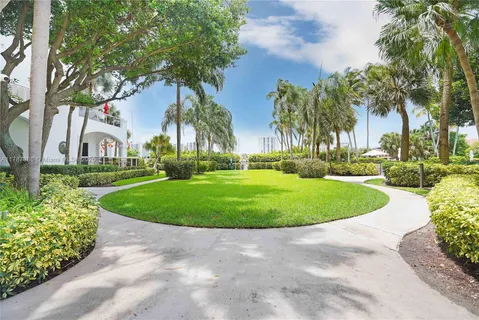 a front view of a multi story building with yard