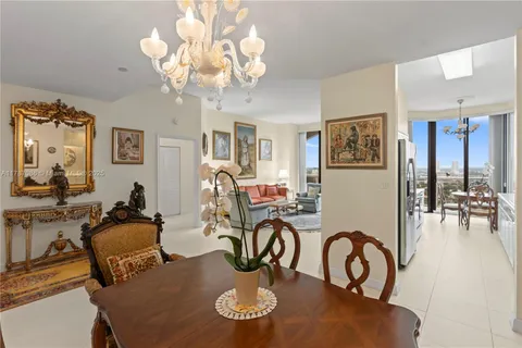 a living room with furniture a rug and a large window