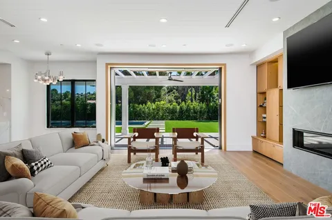 a patio with a table and chairs and a barbeque