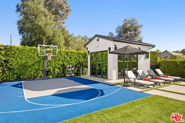 a view of swimming pool with a garden and deck