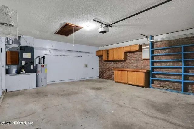 a view of an empty room with furniture and a ceiling fan