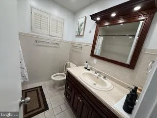 a bathroom with a sink a toilet and mirror