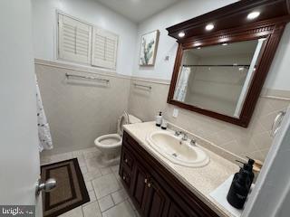 8613 Leonard Drive Silver Spring, MD 20910 - Photo 16 of 27 a bathroom with a sink a toilet and mirror