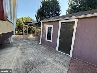 a view of a house with a porch and furniture