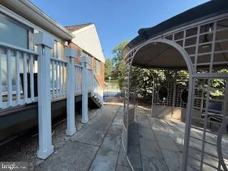a view of a chairs and table in backyard of the house
