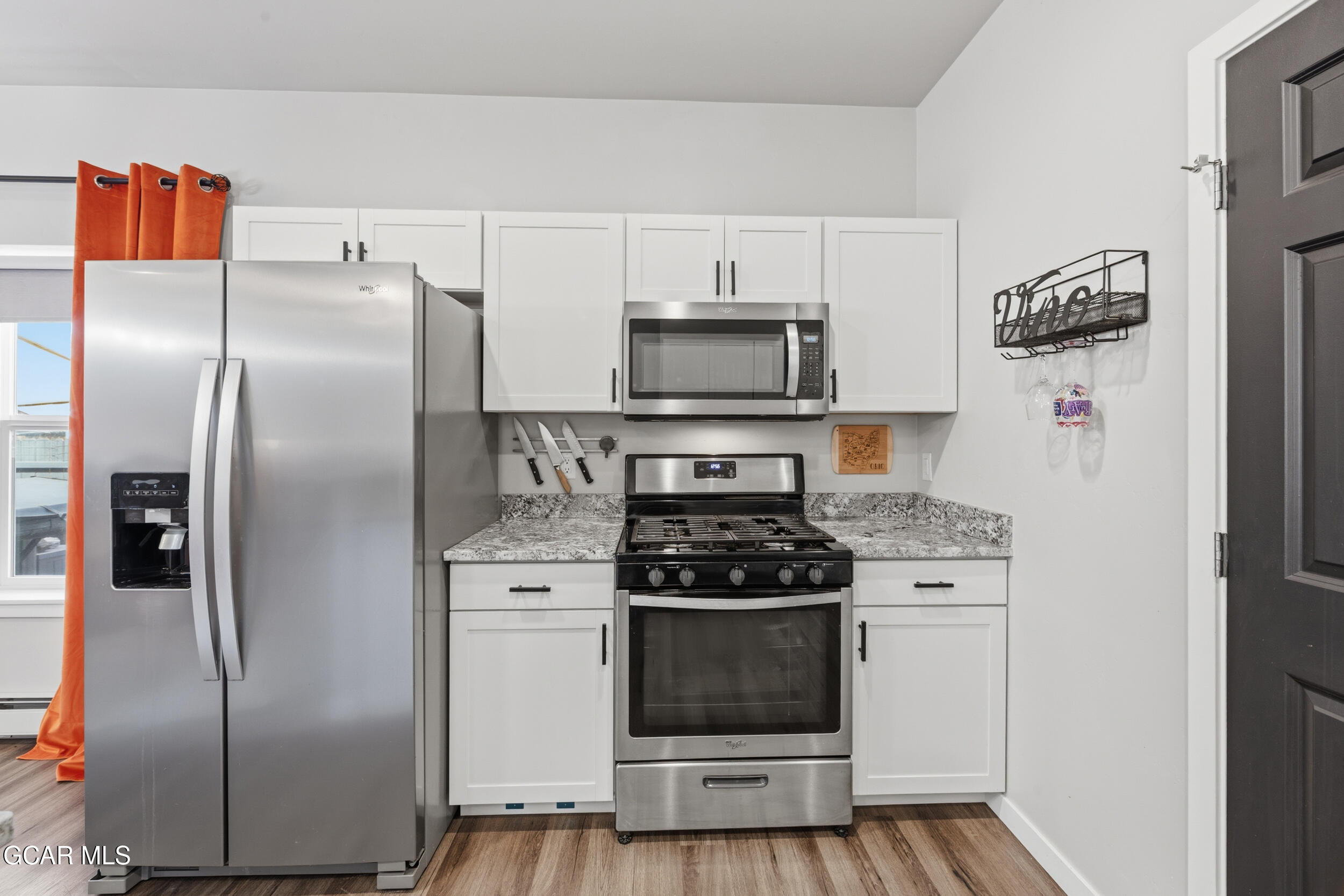 503 12th Street, Unit B Kremmling, CO 80459 - Photo 8 of 44 a kitchen with stainless steel appliances a refrigerator a stove a microwave and cabinets