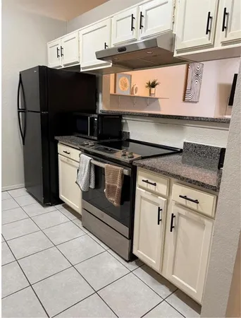 a kitchen with stainless steel appliances granite countertop a stove and a refrigerator