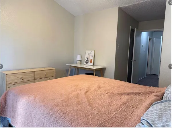 a bedroom with a bed and a mirror
