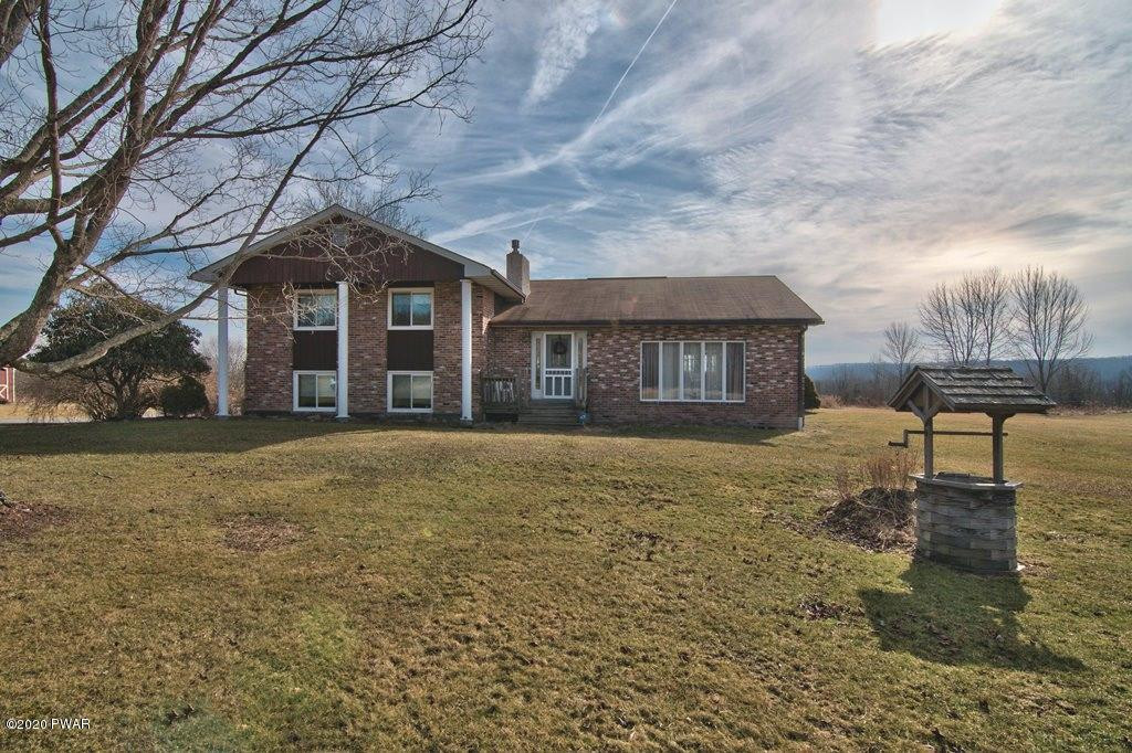 682 Stock Farm Road Lake Ariel, PA 18436 - Photo 1 of 78 a front view of a house with a yard