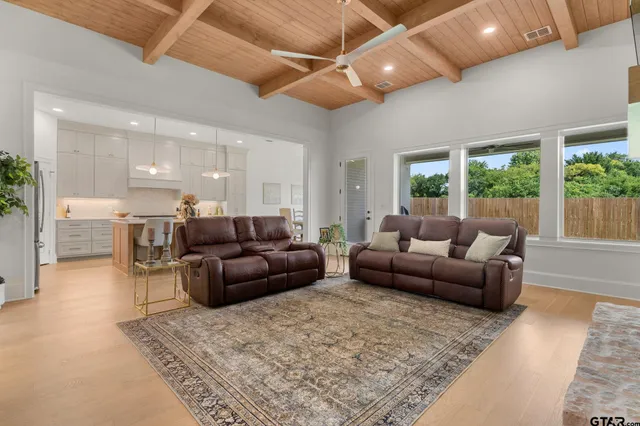 a large kitchen with kitchen island a table and chairs in it