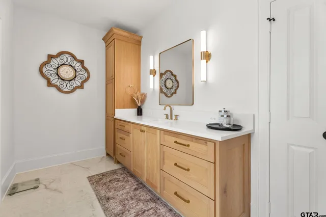 a view of walk in closet with clothes