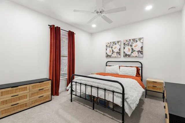 a bedroom with a bed and a cabinet