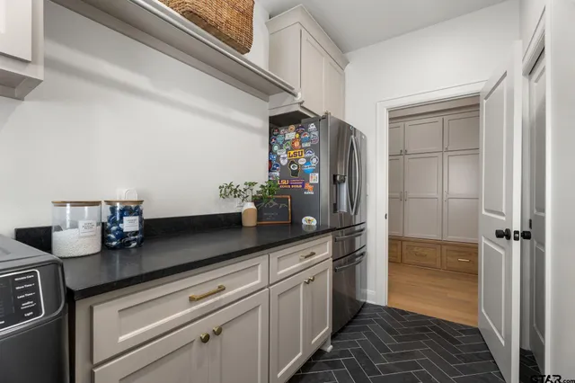 a kitchen with stainless steel appliances granite countertop a sink and a stove