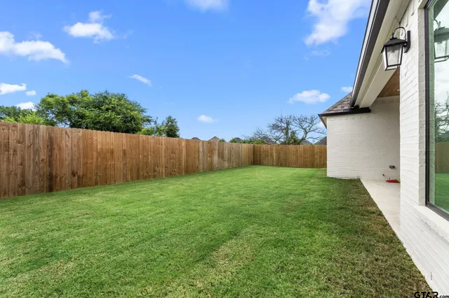 a view of a backyard with furniture and a garage