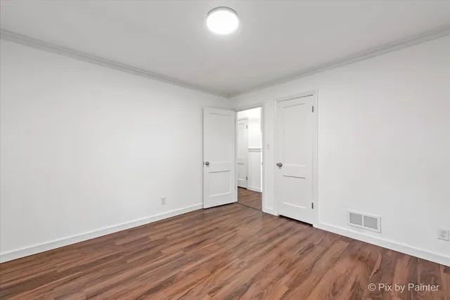a view of an empty room and wooden floor