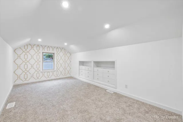 an empty room with a empty space and windows