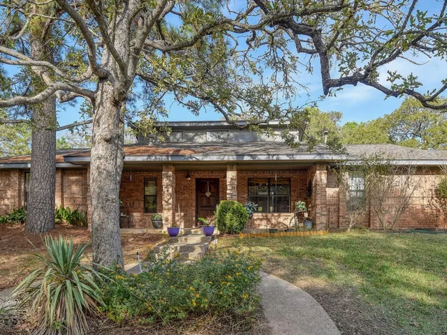 front view of a house with a tree in front of it