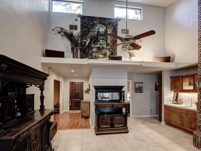 a kitchen with a sink a stove a microwave cabinets and dining table