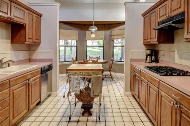 a kitchen with stainless steel appliances granite countertop a refrigerator oven stove a sink and dishwasher