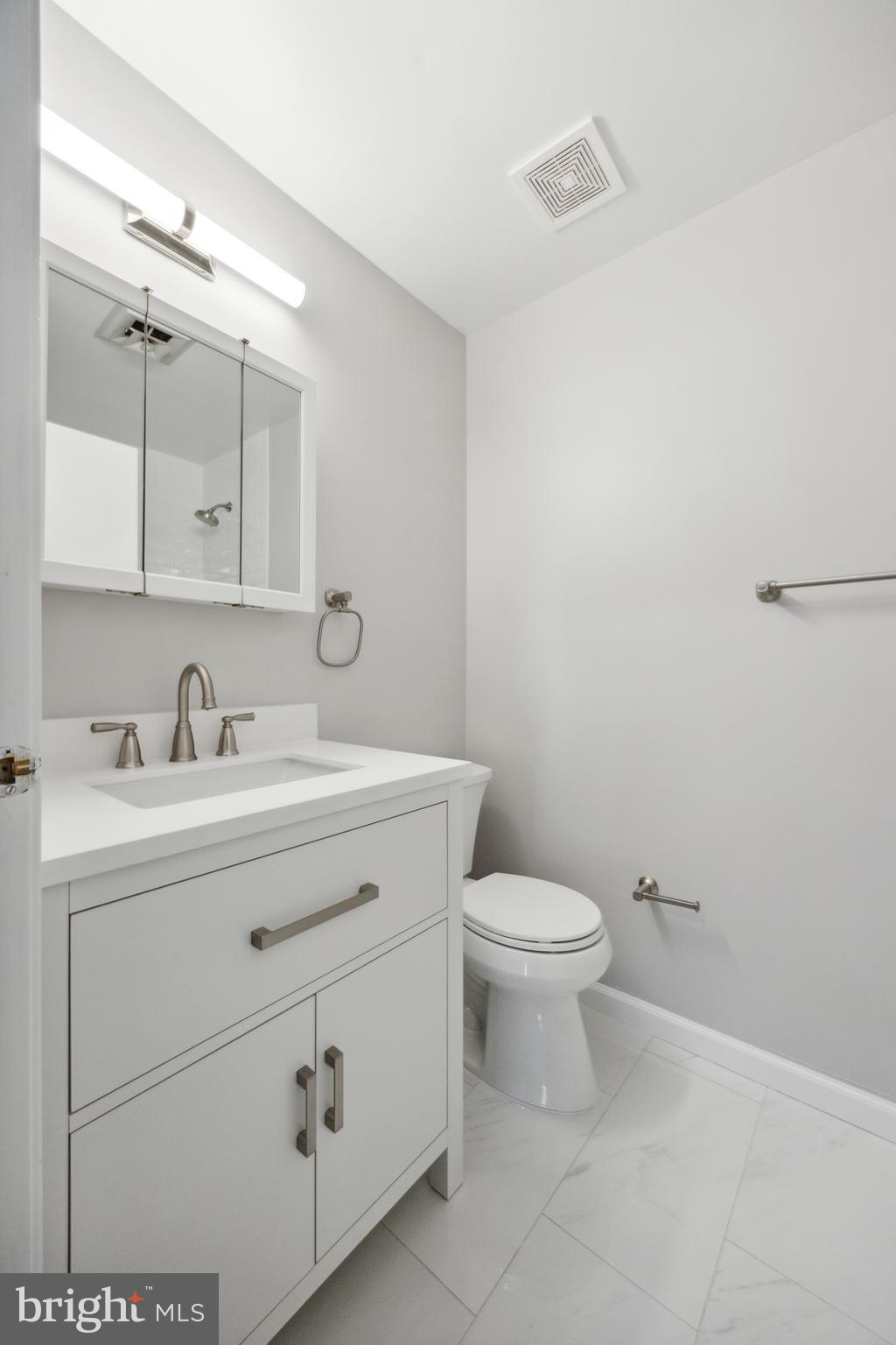 411 Conestoga Road, Unit 27 Devon, PA 19333 - Photo 12 of 15 a bathroom with a toilet sink and mirror