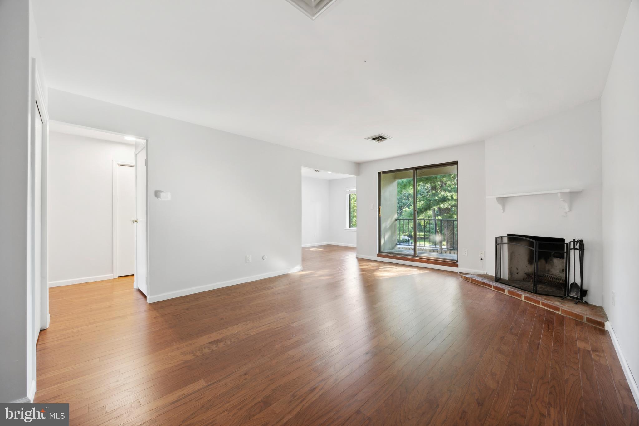 411 Conestoga Road, Unit 27 Devon, PA 19333 - Photo 5 of 15 an empty room with wooden floor and windows