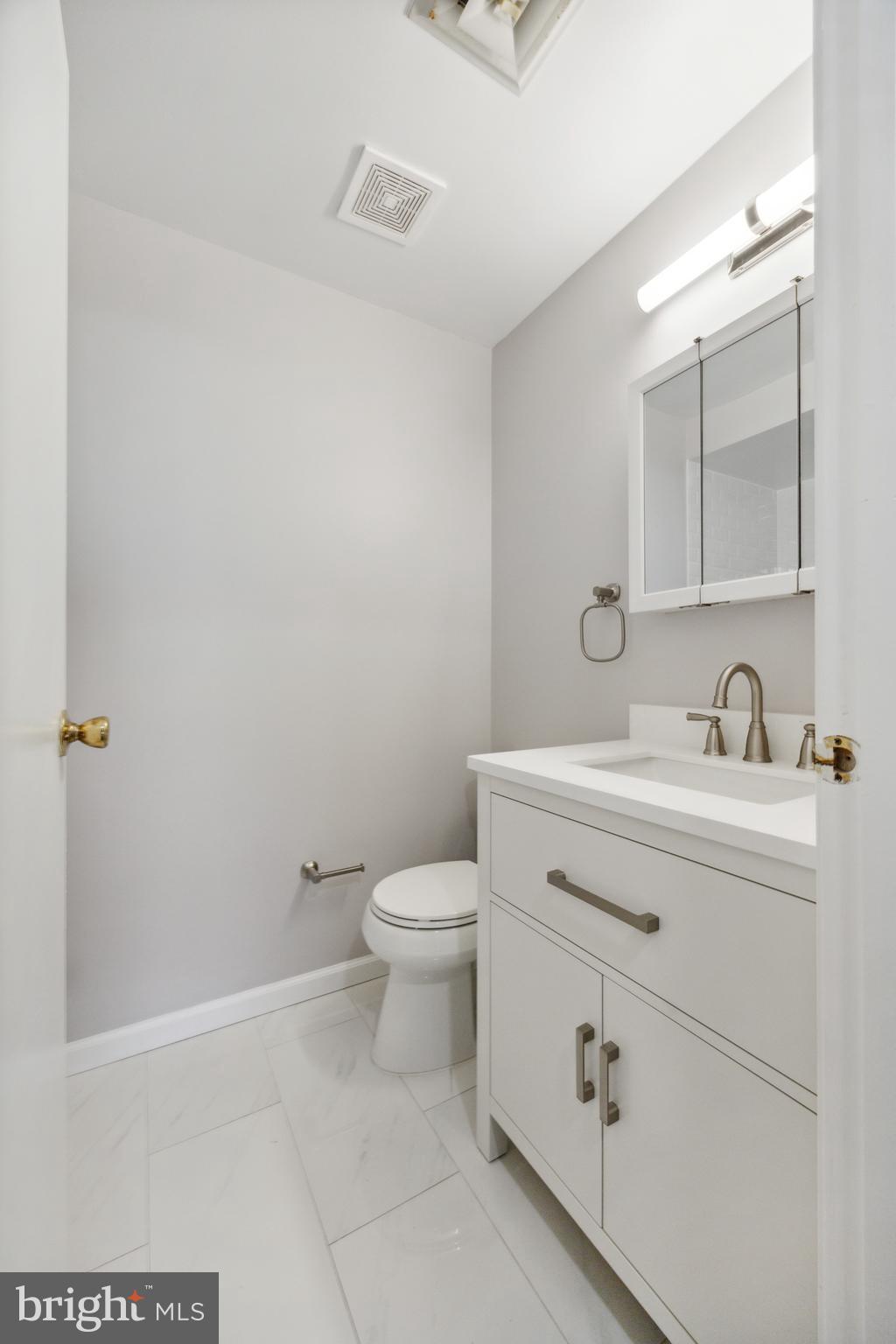 411 Conestoga Road, Unit 27 Devon, PA 19333 - Photo 10 of 15 a bathroom with a sink a toilet and a mirror
