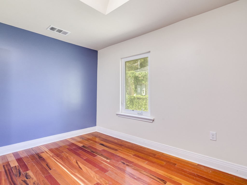 2314 Santa Rosa Street Austin, TX 78702 - Photo 13 of 27 Spare room featuring light wood-style flooring and baseboards