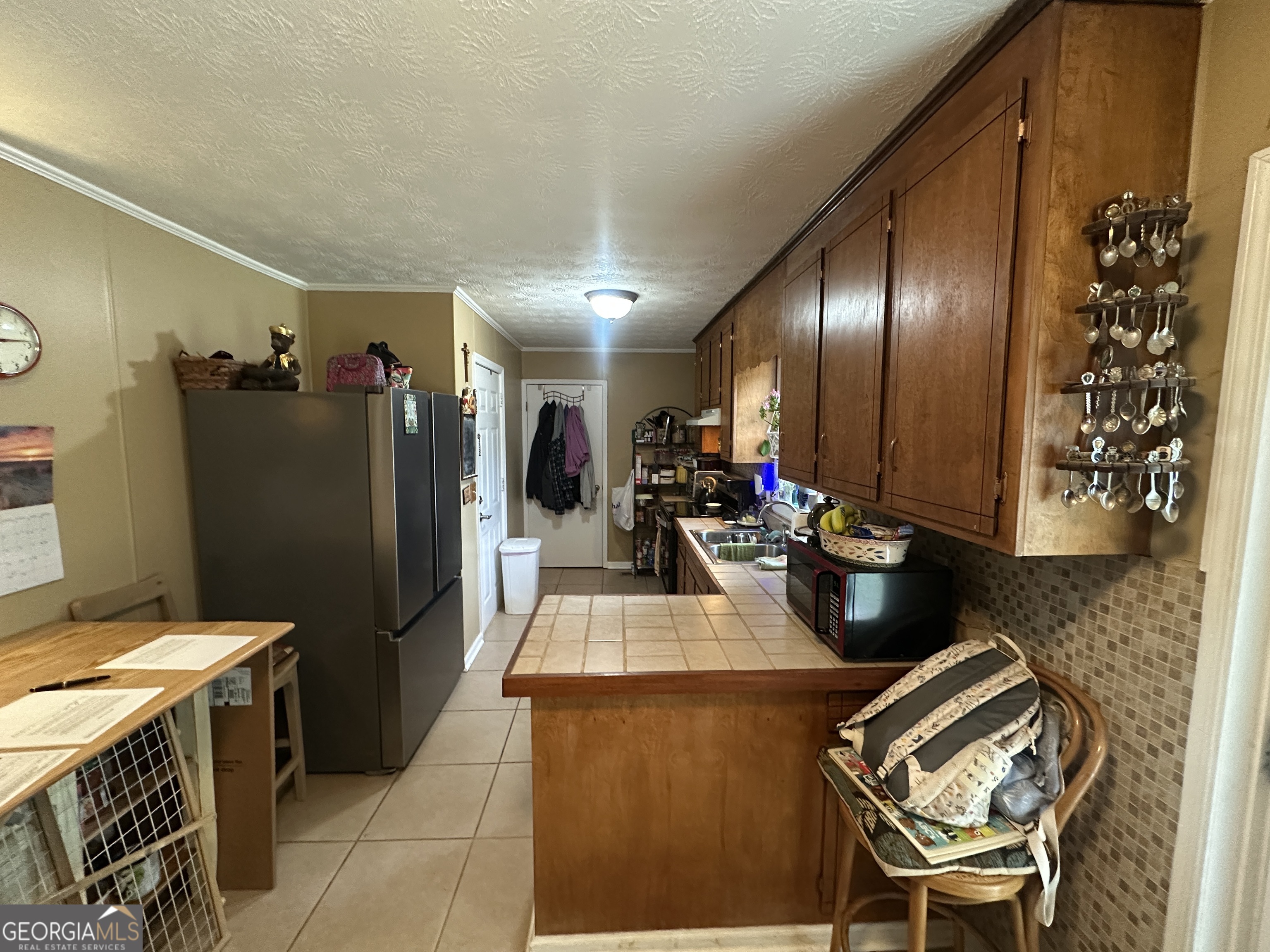 183 Garrison Road Cornelia, GA 30531 - Photo 18 of 27 a kitchen with a refrigerator and a sink