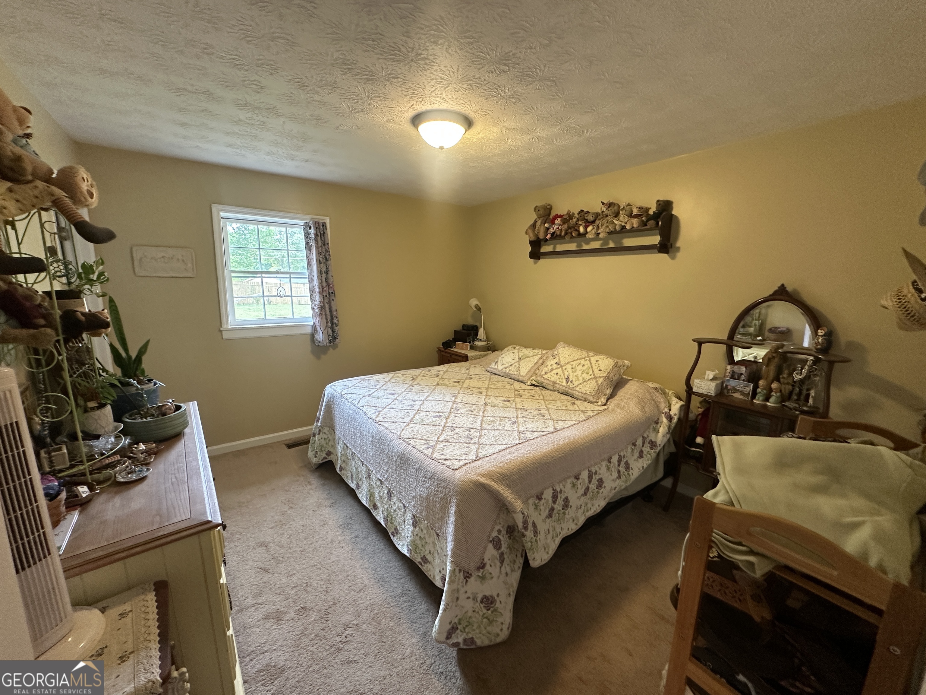 183 Garrison Road Cornelia, GA 30531 - Photo 24 of 27 a bedroom with a bed and wooden floor