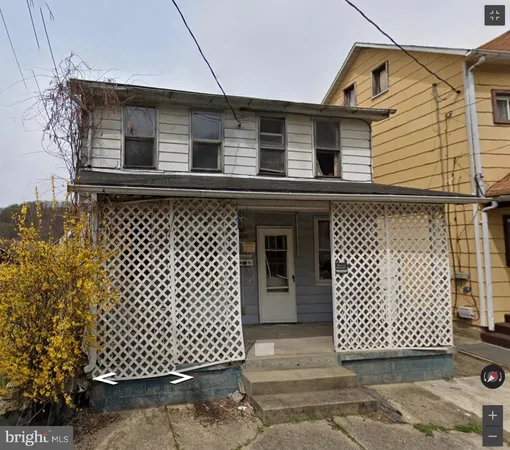 a front view of a house with wooden fence