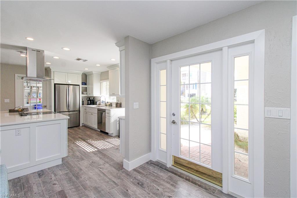 1353 Pelican Avenue Naples, FL 34102 - Photo 11 of 41 a kitchen with white cabinets and appliances