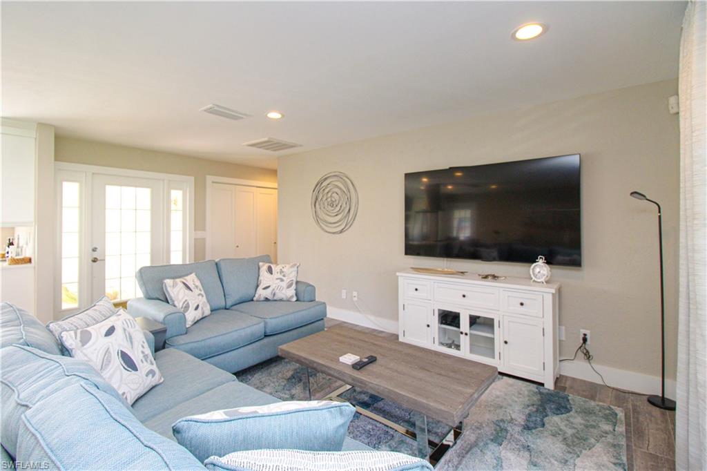 1353 Pelican Avenue Naples, FL 34102 - Photo 12 of 41 a living room with furniture and a flat screen tv
