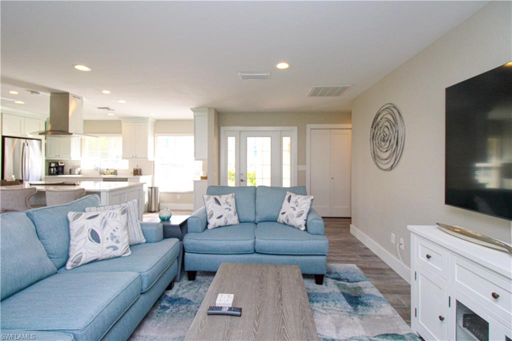 1353 Pelican Avenue Naples, FL 34102 - Photo 14 of 41 a living room with furniture and a flat screen tv