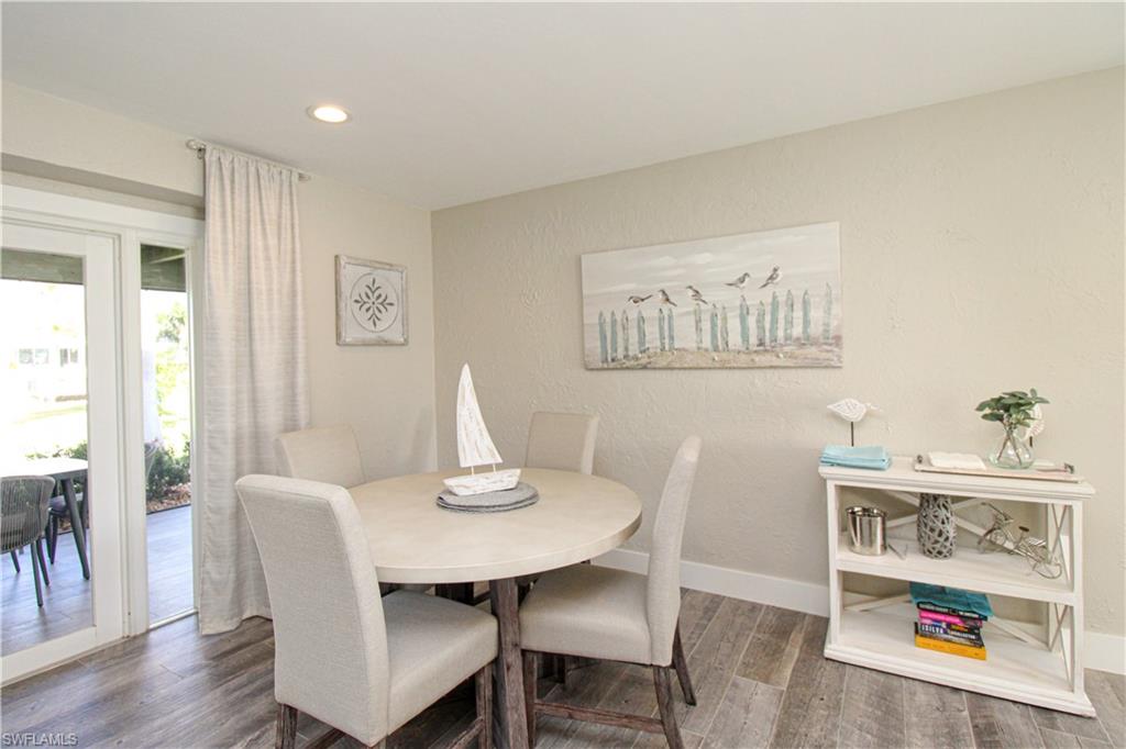 1353 Pelican Avenue Naples, FL 34102 - Photo 16 of 41 a view of a dining room with furniture and wooden floor