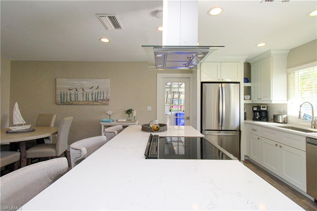 1353 Pelican Avenue Naples, FL 34102 - Photo 17 of 41 a kitchen with refrigerator and window