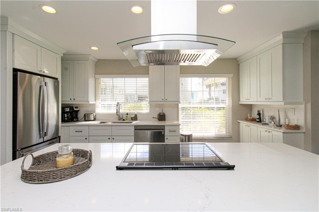 1353 Pelican Avenue Naples, FL 34102 - Photo 18 of 41 a large kitchen with a stove a refrigerator and a large window